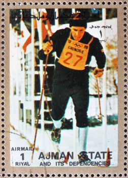 AJMAN - CIRCA 1973: a stamp printed in the Ajman shows Cross-country Skiing, Winter Olympics, circa 1973