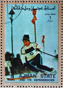 AJMAN - CIRCA 1973: a stamp printed in the Ajman shows Slalom, Alpine Skiing, Winter Olympics, circa 1973