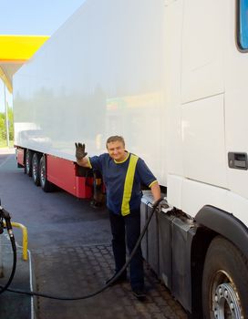 Driver at a gas station run by the truck