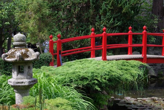 A red bridge in a Japanese garden in Ireland