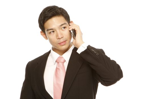 A man in business attire using a mobile phone (on white)