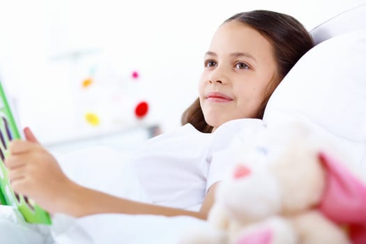 Portrait of girl with a book in bed at home