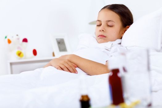 Little girl with illness at bed at home