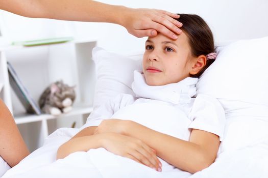 Little girl with illness at bed at home