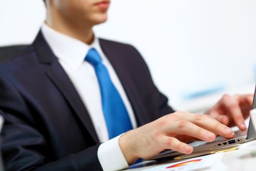 Young manager working with notebook in the office