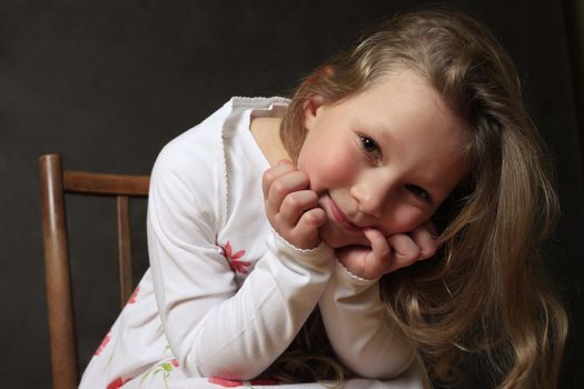 Portrait of young girl smiling on black background