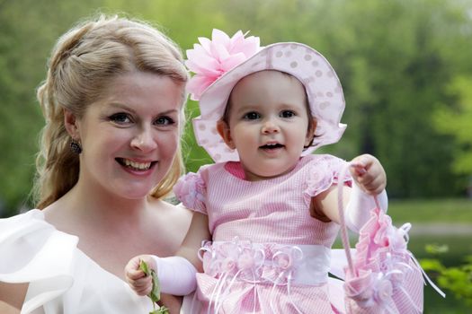 Portrait of beautiful happy smiling mother with baby outdoor, on nature