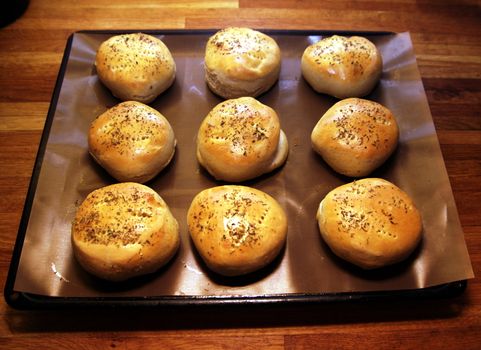 Freshly baked hamburger breads on a plate