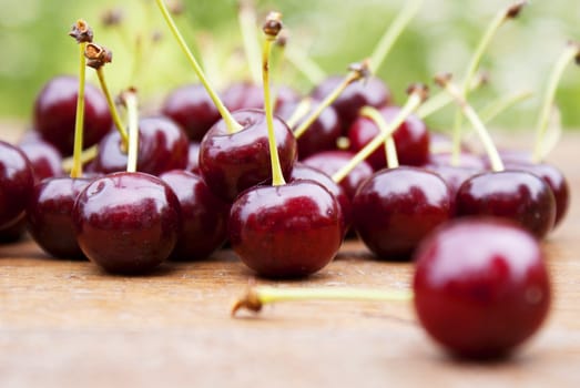 Ripe fresh berries of a cherry on an old wooden table