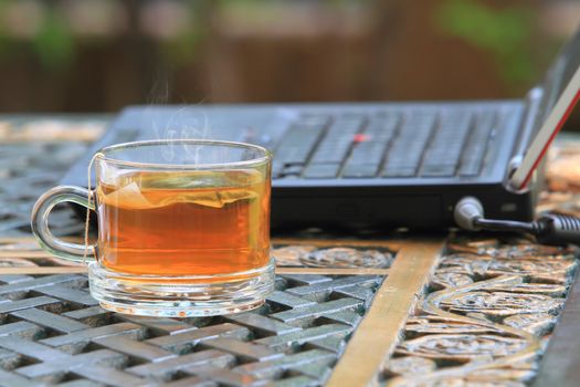 Laptop keyboard and tea cup