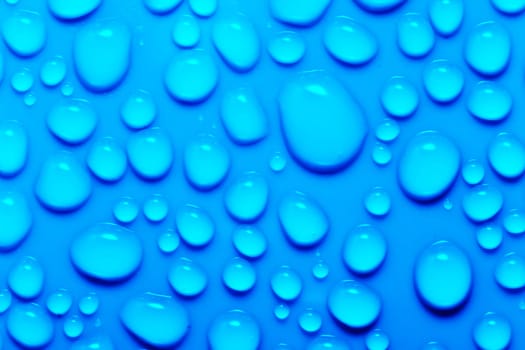 Water drops on a green surface