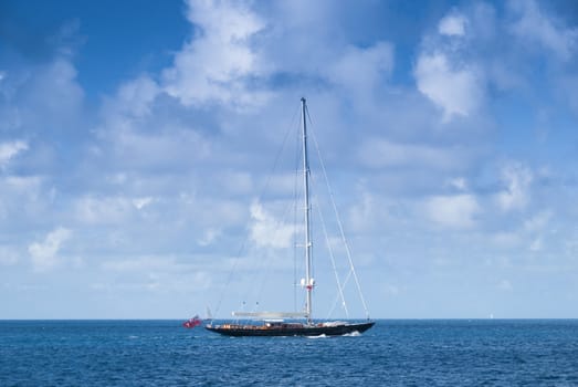 Large sailboat moving between islands in the caribbean