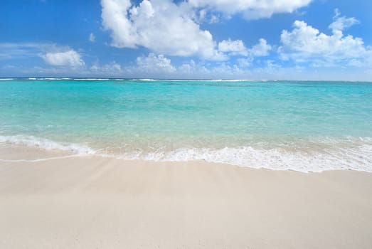 Caribbean island beach with turquoise waters and white sand
