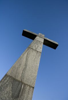 Cross symbol in front of blue sky