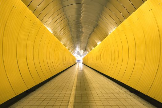 Yellow tunnel with people out of focus