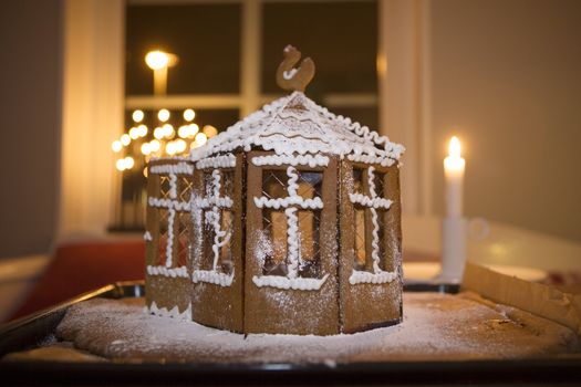 Decorated Gingerbread House and candles