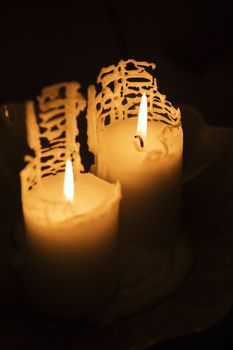 Burning candles on black background