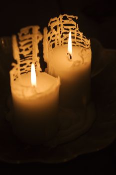 Burning candles on black background