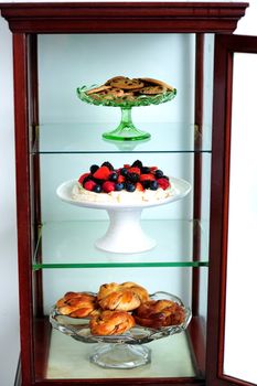 Shelf decorated by delicious desserts. Yummy three