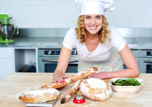 Bakery woman preparing healthy food. Looking and smiling at camera