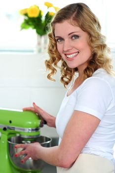 Pretty female chef at work in restaurant kitchen
