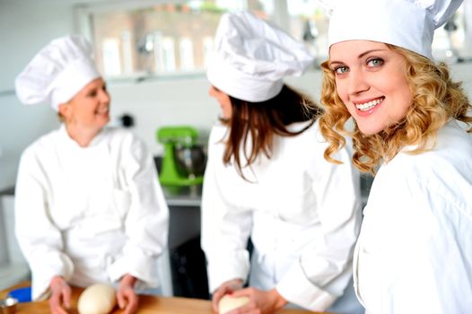 Group of professional female chefs in commercial kitchen