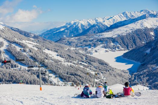 Snowboarders on the Alpine skiing resort in Austria Zillertal