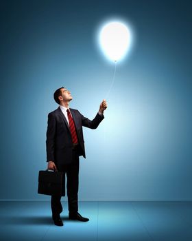 Light bulb and a business person as symbols of creativity in business