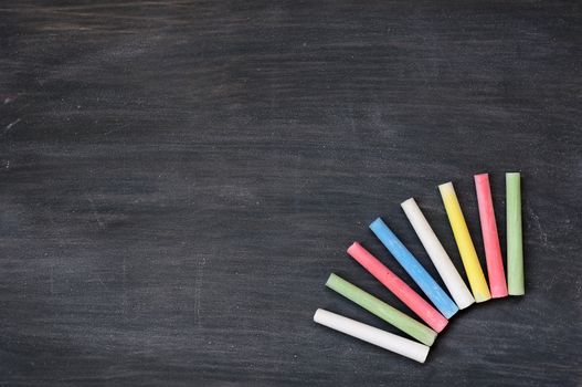 Blank smudged blackboard background with colorful chalk for text writing and design