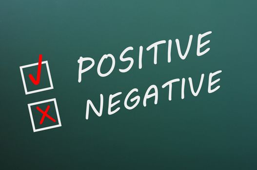 Chalk drawing of Positive and negative with check boxes on a green chalkboard