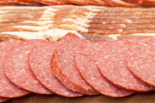 Assorted Slice Sausage and Bacon on Cutting Board, closeup