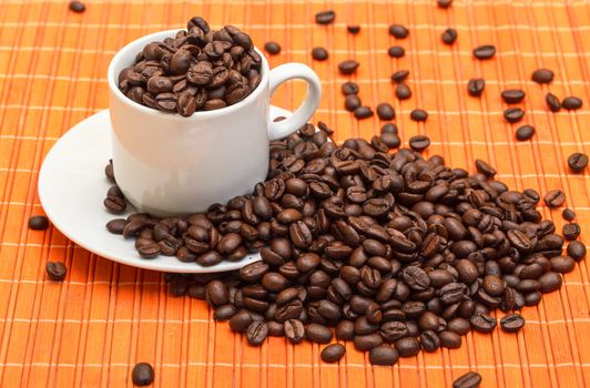 Cup with Coffee Beans on Bamboo Mat