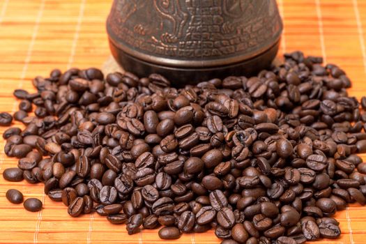 Cezve and Coffee Beans on Bamboo Mat, closeup