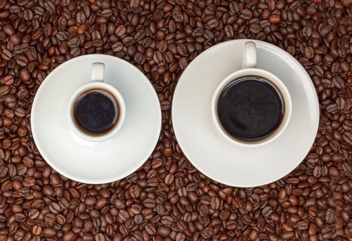 Cups with Hot Coffee on Background Coffee Beans