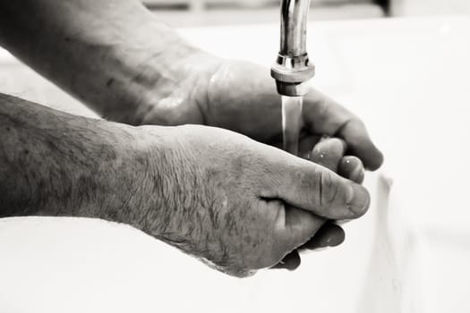 Man washing hands in bathroom