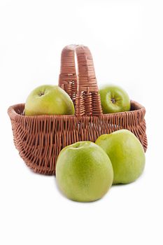 Ripe green apple in basket over white