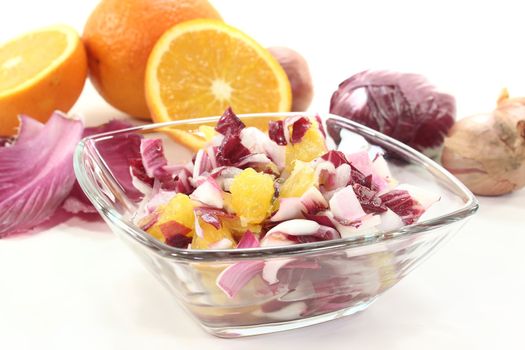 red chicory salad with orange slices and dressing