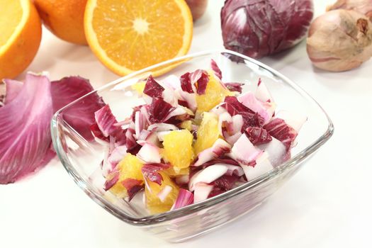 fresh red chicory salad with orange slices and dressing