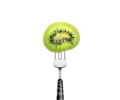 kiwi slice pierced by fork, isolated on white background