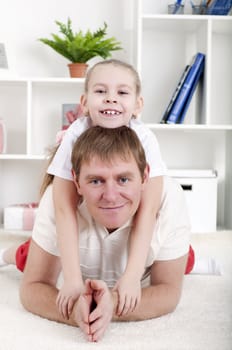 Portrait of happy family lying together, hugging and happy