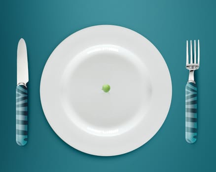 green peas on white plate with knife and fork on blue background.
