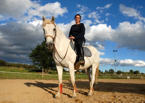 training in dressage for a white horse and her riding girl