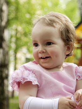 portrait of blond small girl in park