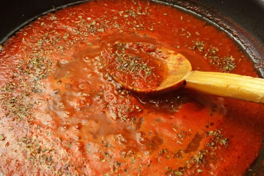 making pizza sauce with tomatoes and oregano