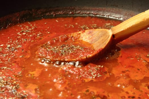 preparing tomato sauce for pizza and spaghetti