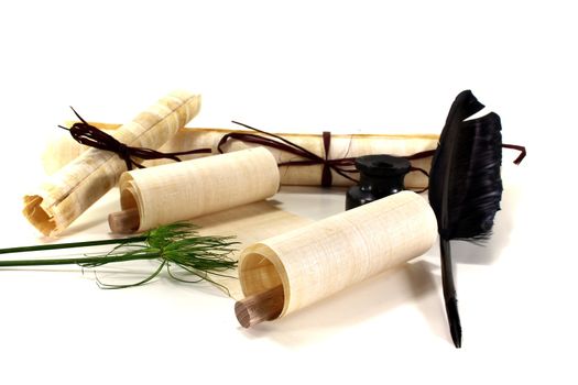 papyrus scrolls with pen, inkwell and papyrus on a light background