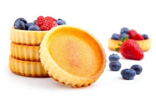 dessert fruit cake with strawberries and blueberries, over a white background.