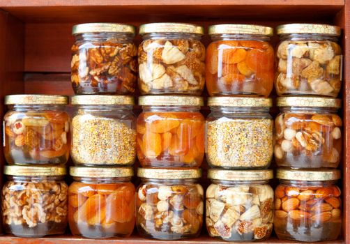 colorful honey with fruit and nuts in the jar, on a market in croatia.