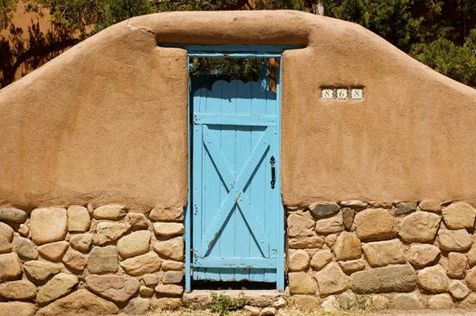 New Mexican Adobe characterful doorway (blue), with copy space.
