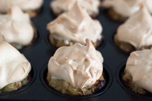 Gooseberry meringue cupcakes or muffins still in baking mould
